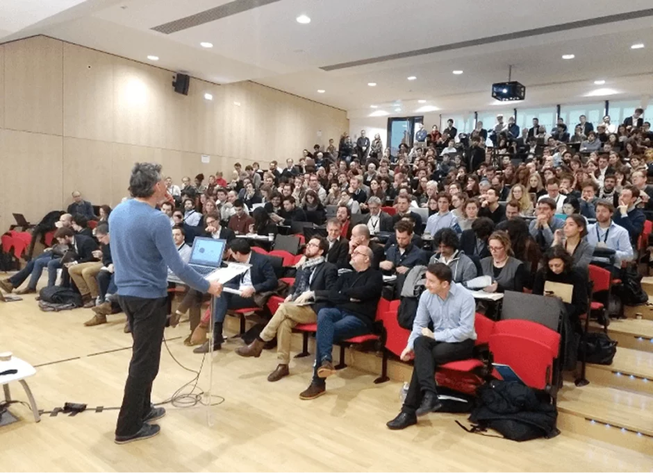 A lecture in a packed auditorium at the Paris School of Economics